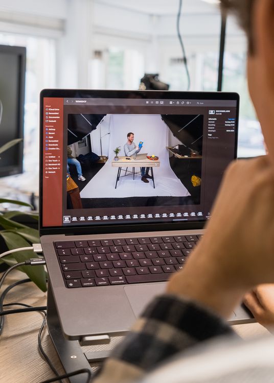 A Mac user applying photo editing tips while editing a photo.