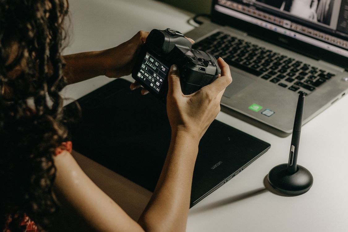 A photographer learning how to edit raw photos on a Mac.