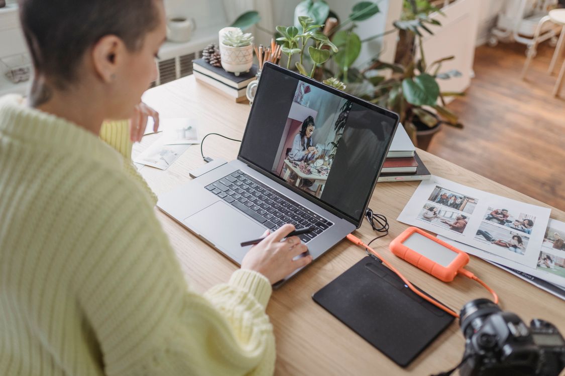 A person editing photos on a Mac at home