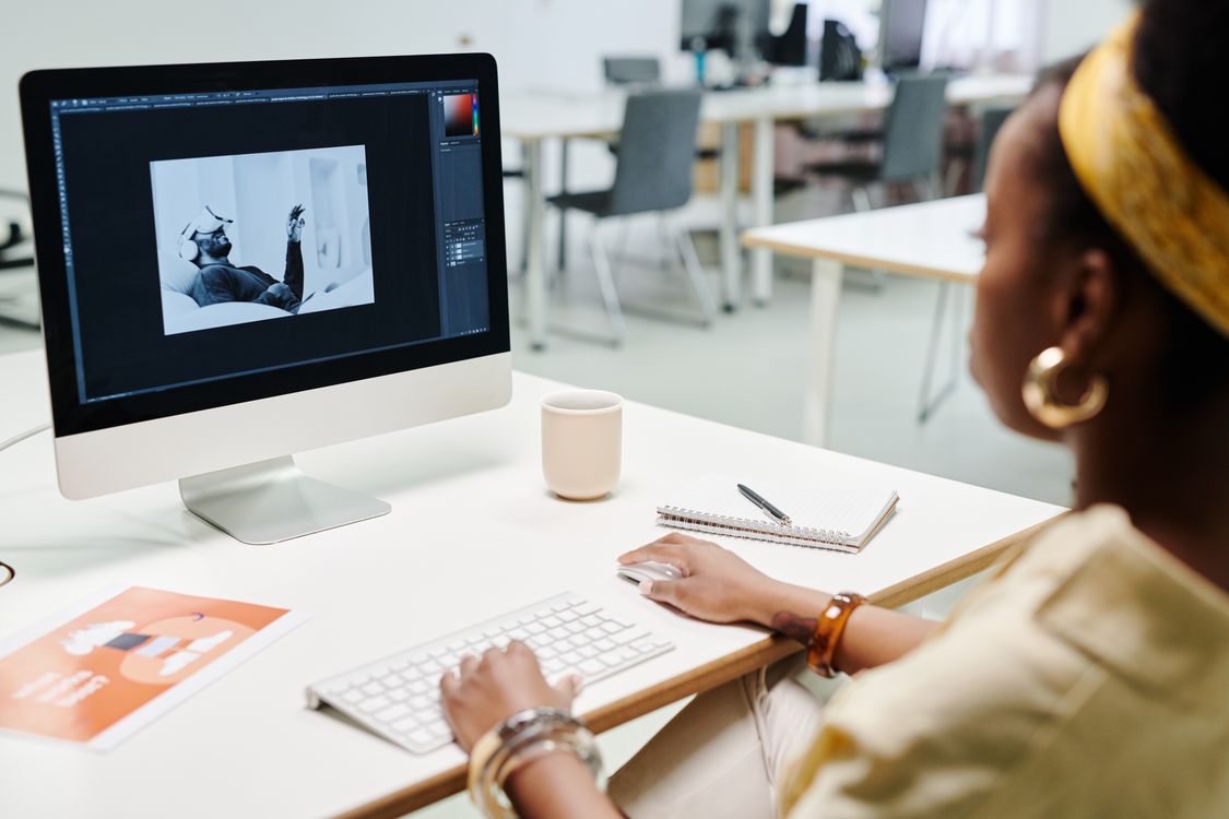 A beginner following a basic and advanced photo editing techniques tutorial on a Mac.